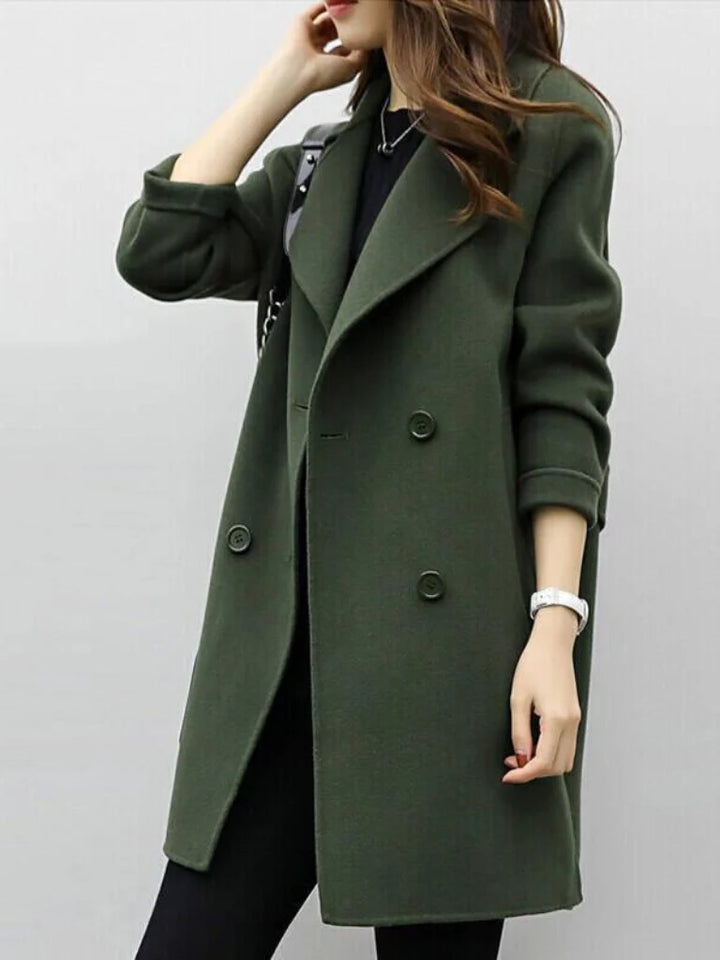 Side view of women's longline coat showing structured shoulder line and relaxed fit through body