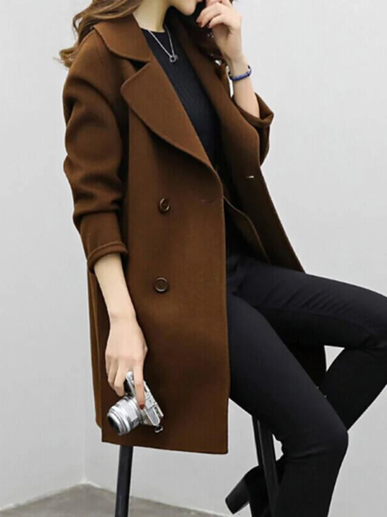 Back view of women's knee-length coat displaying straight-cut silhouette and structured fabric