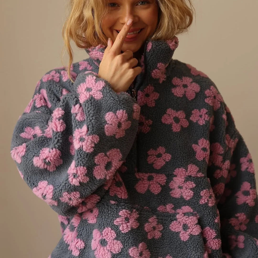 Detail of half-zip closure on women's floral teddy fleece jacket with retro print