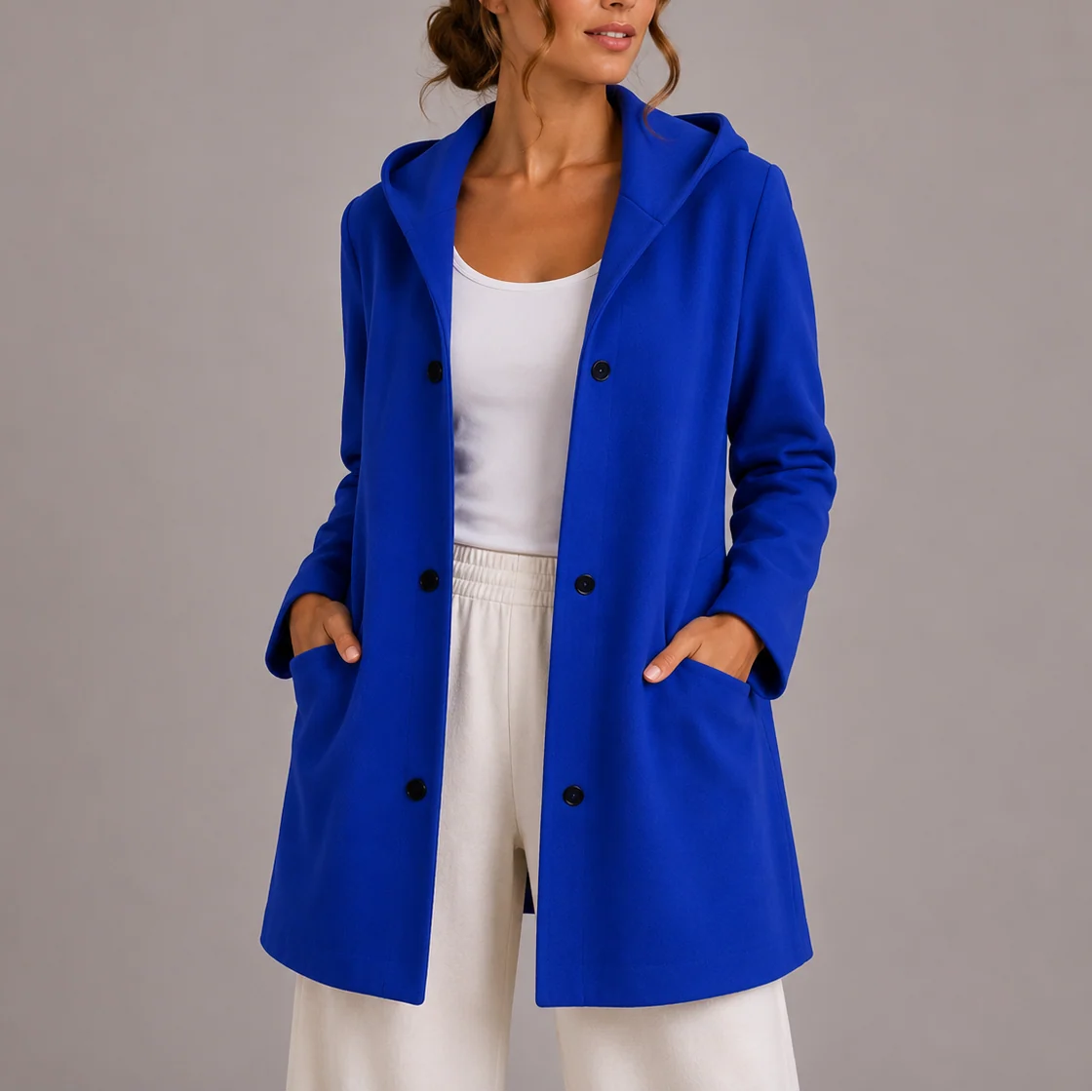 Women's hooded jacket styled with casual white top and trousers for everyday wear