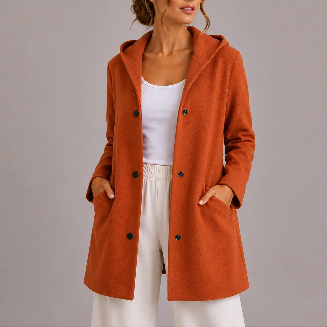 Back view of hooded double-breasted jacket showing relaxed fit and hood detail