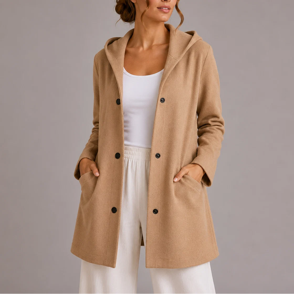 Women's hooded double-breasted jacket in casual layering outfit for transitional weather