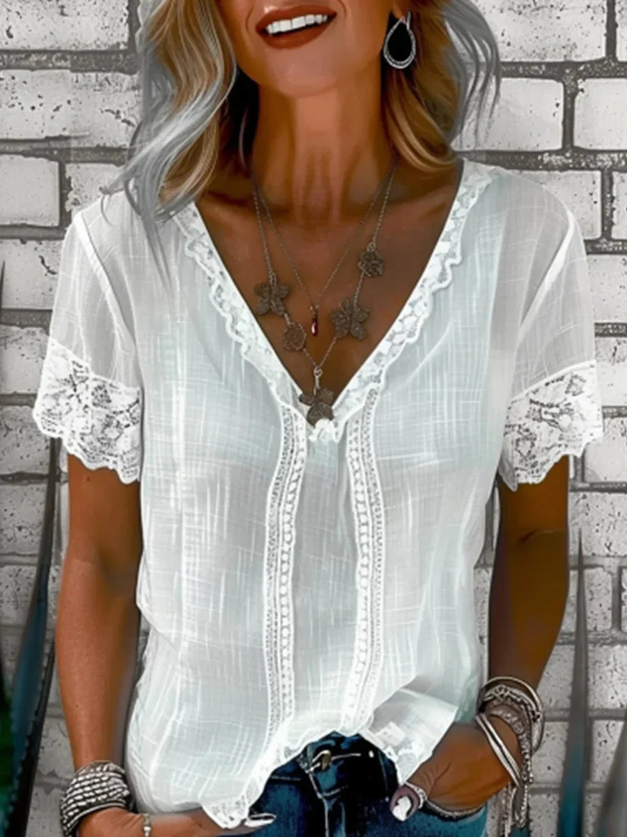 Women's lace trim blouse with V-neckline and short sleeves featuring scalloped lace detailing on white textured fabric