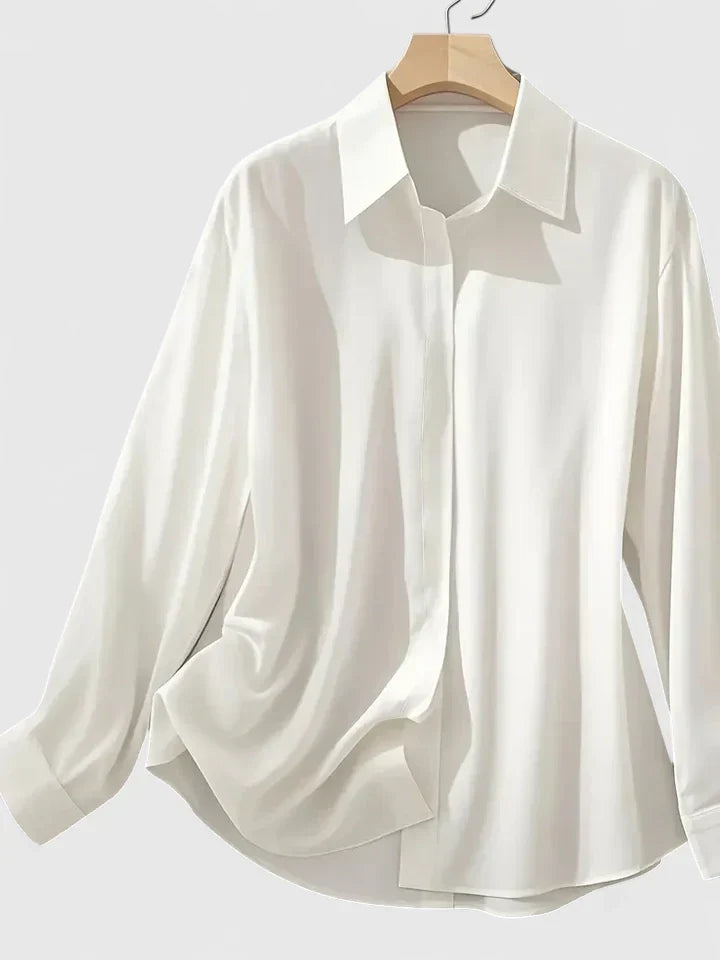 Women's relaxed fit shirt in white with classic collar and hidden button closure on hanger