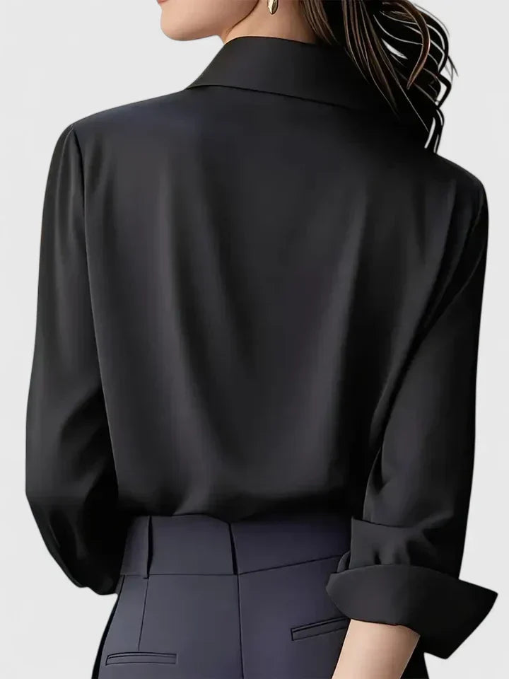 Women's white shirt with long sleeves and button cuffs displayed from front angle