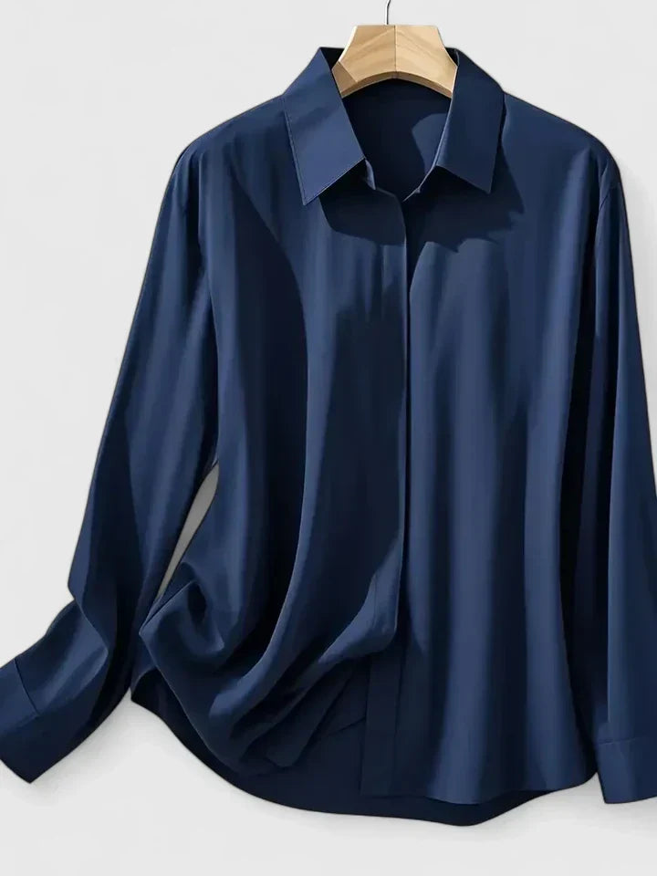 Relaxed fit shirt with structured collar and smooth finish fabric on wooden hanger