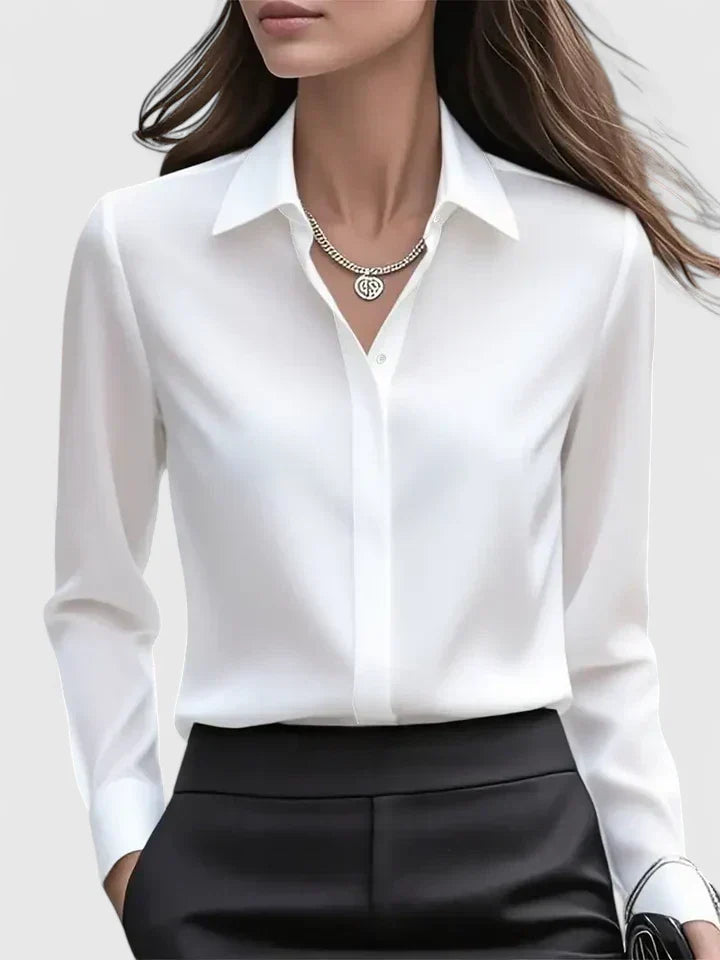 Detail of hidden button closure and minimalist front design on women's shirt