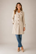 Close-up view of beige tailored trench coat showing structured fabric and button details