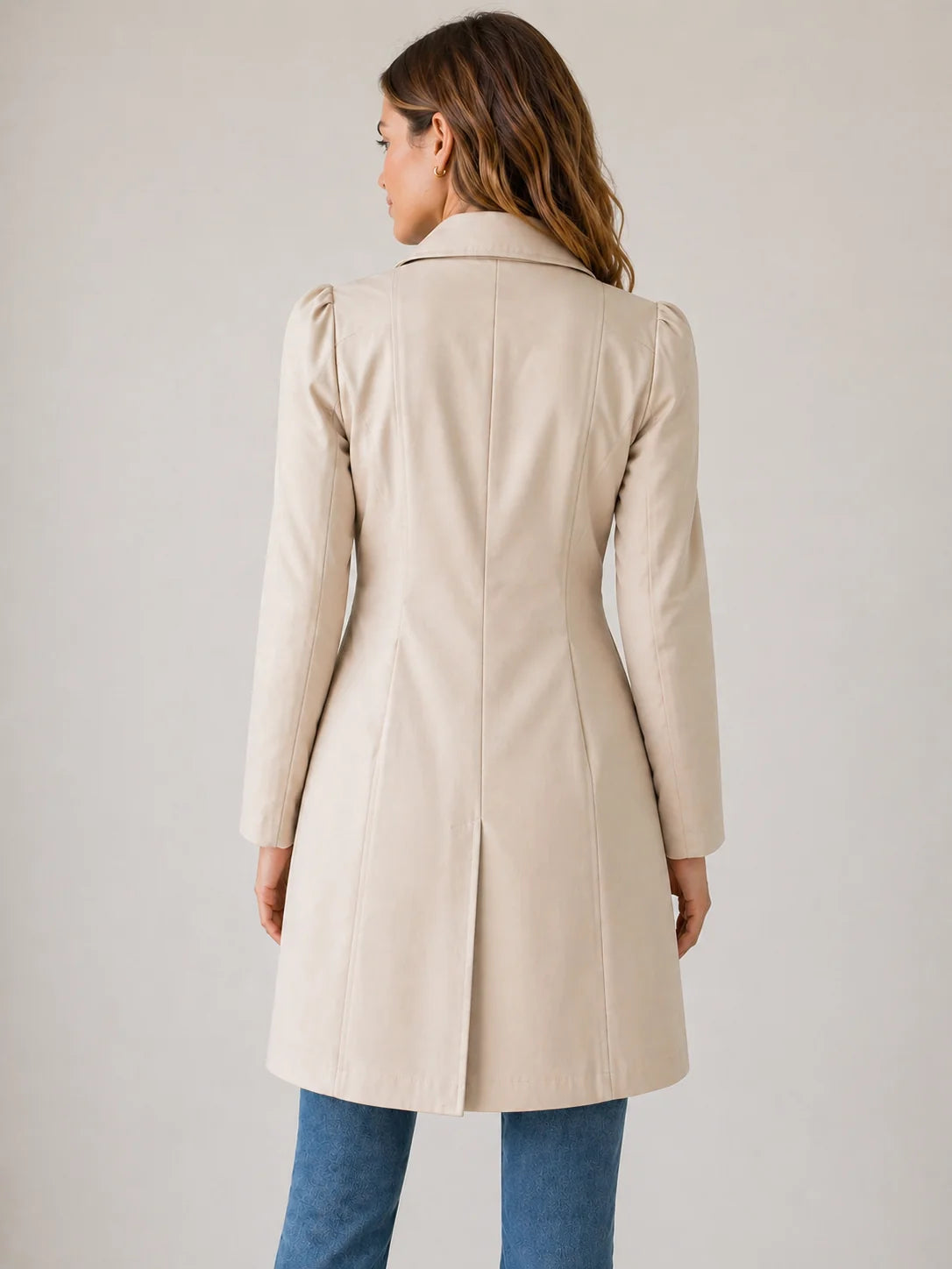Detail of notched collar and button closure on tailored trench coat