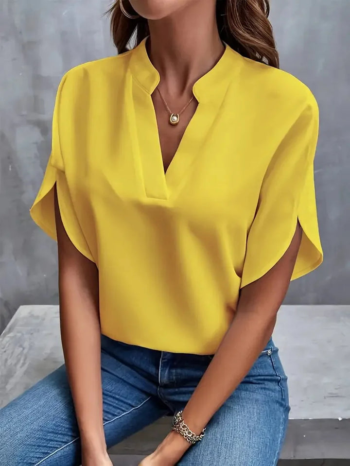 Full-length view of V-neck blouse showing relaxed fit and versatile styling options