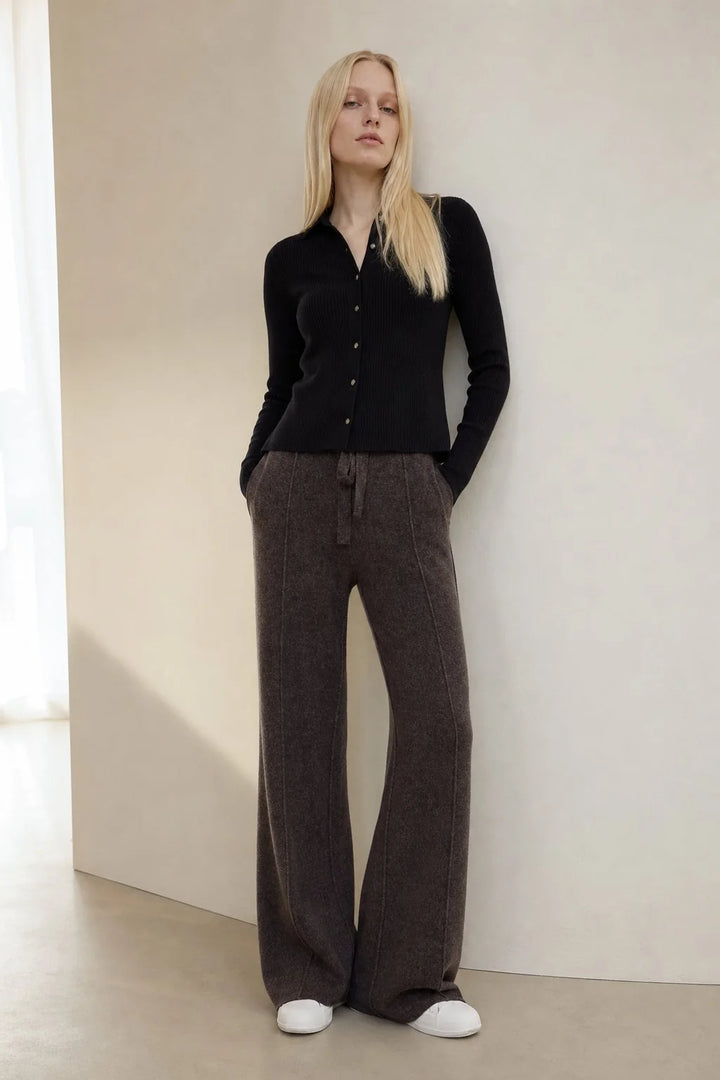 Woman in beige wool trousers showing full-length wide leg cut and soft fabric texture