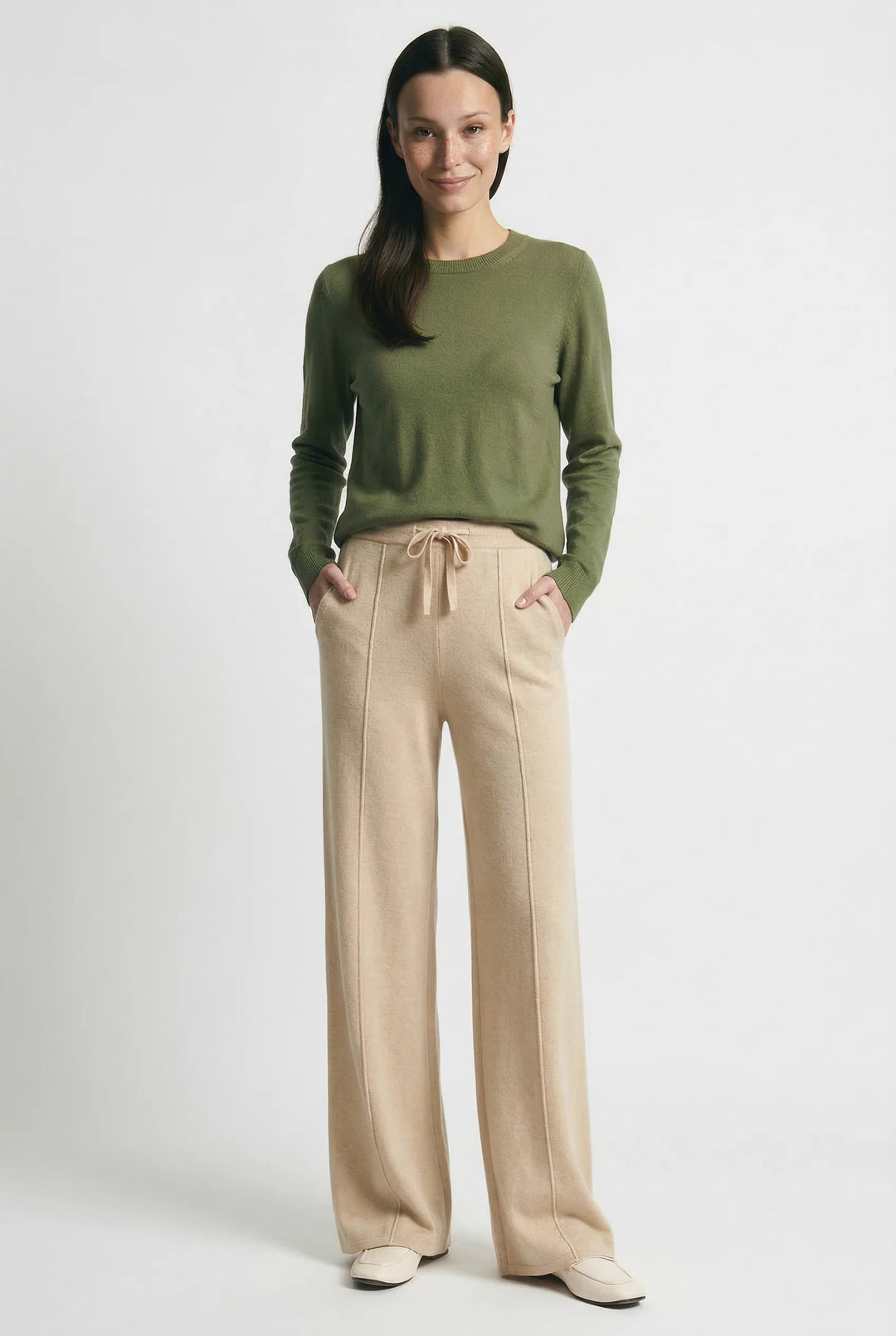 Woman styling wool trousers with casual knit top for autumn winter wardrobe