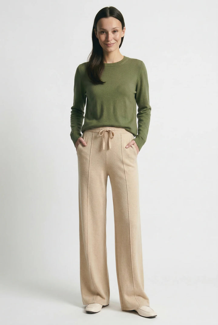 Woman styling wool trousers with casual knit top for autumn winter wardrobe