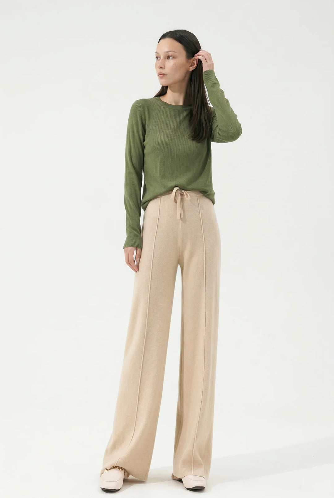 Full body shot of wide leg wool trousers showing relaxed silhouette and elegant drape