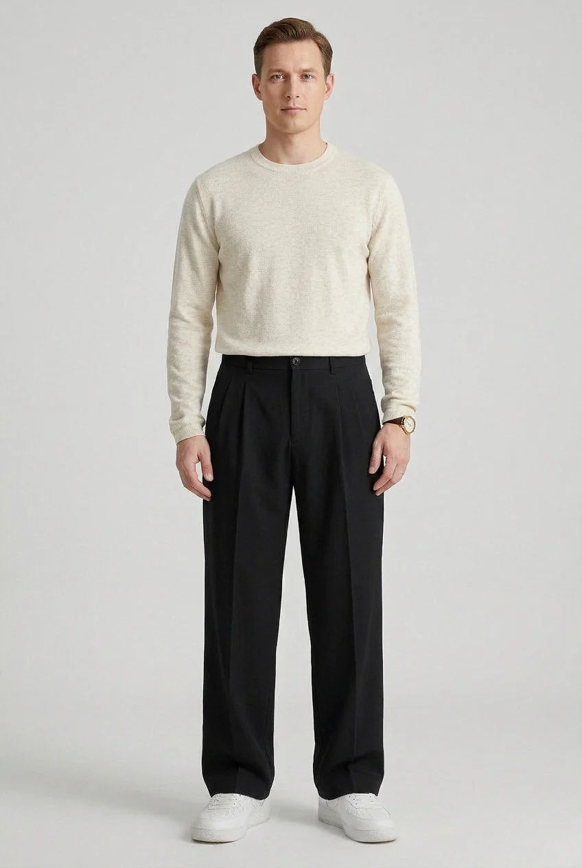 Side view of men's pleated trousers showing structured high waist design and clean lines