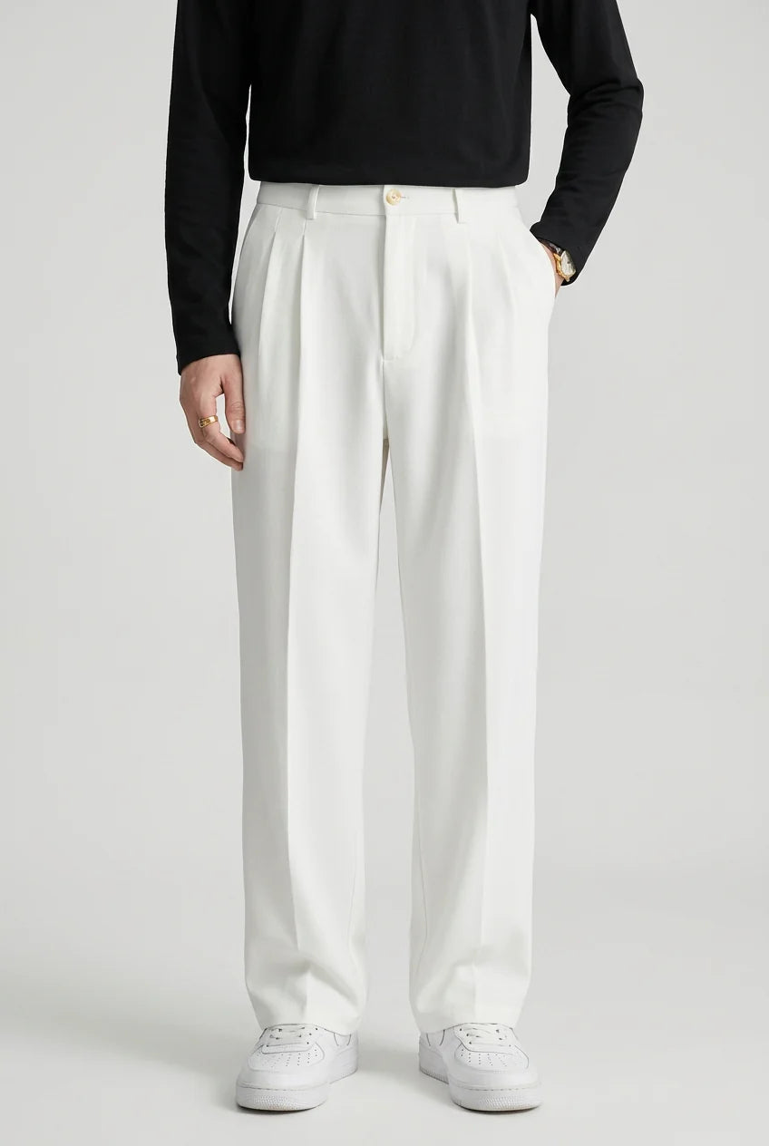 Detail of high waist pleated trousers showing tailored construction and fabric drape