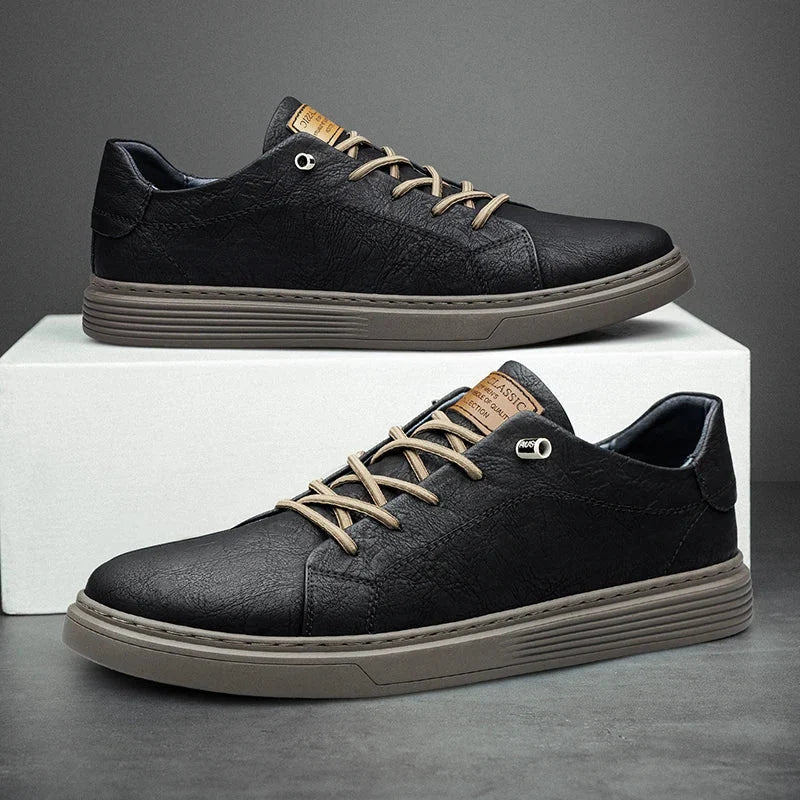 Side view of men's beige trainers showing contrast navy heel tab and tonal stitching
