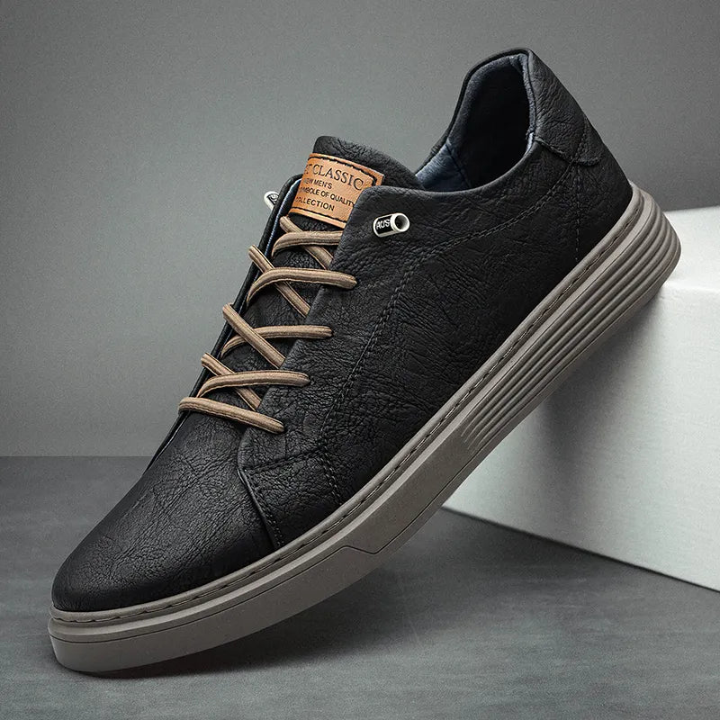 Close-up of men's trainers with tan logo detail and structured upper construction