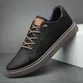 Close-up of men's trainers with tan logo detail and structured upper construction