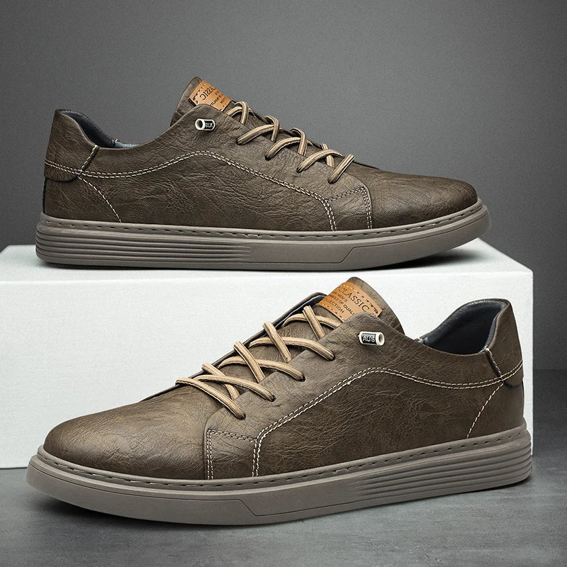 Pair of men's low-top trainers with cushioned sole and clean minimalist design