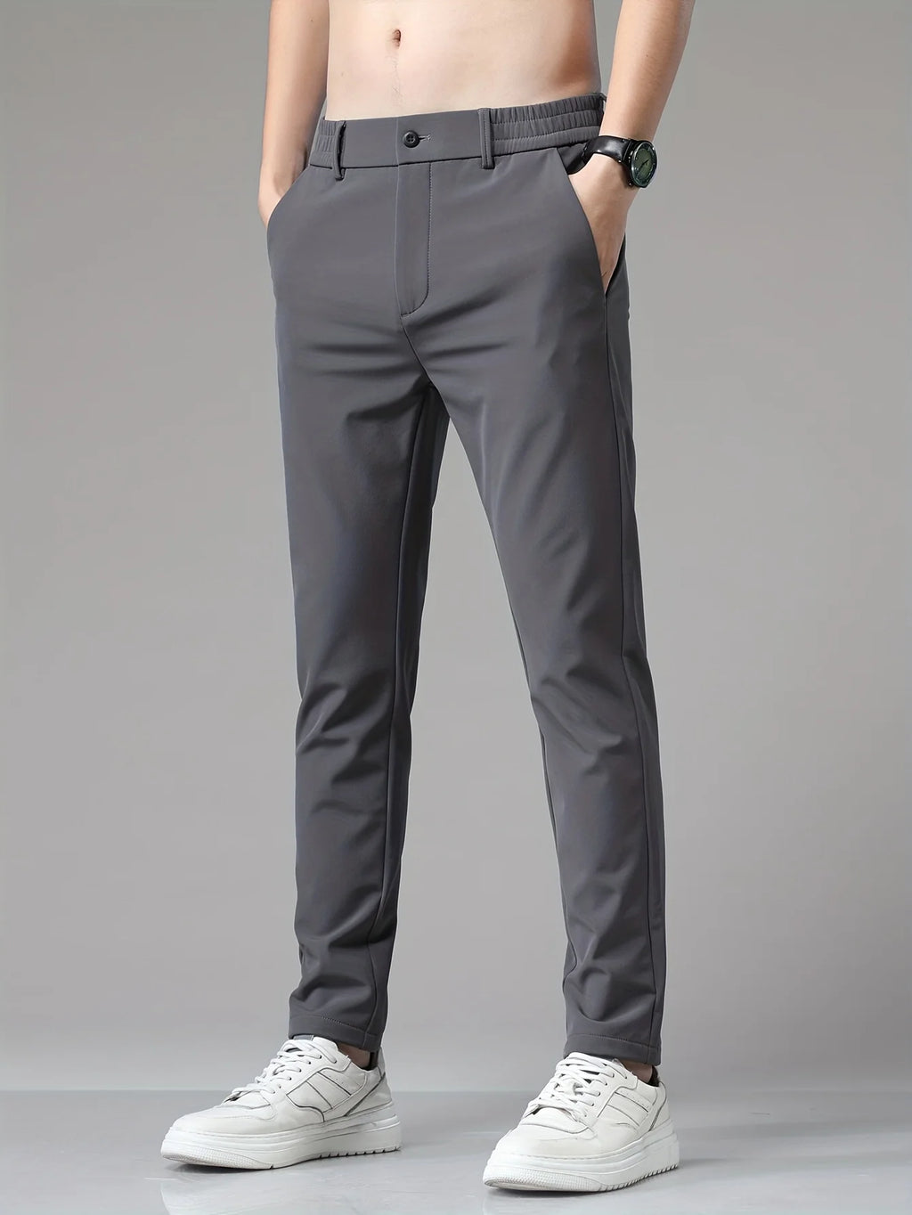 Detail of men's trousers waistband showing mid-rise cut and concealed closure
