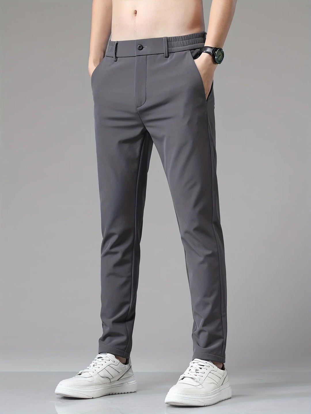 Detail of men's trousers waistband showing mid-rise cut and concealed closure