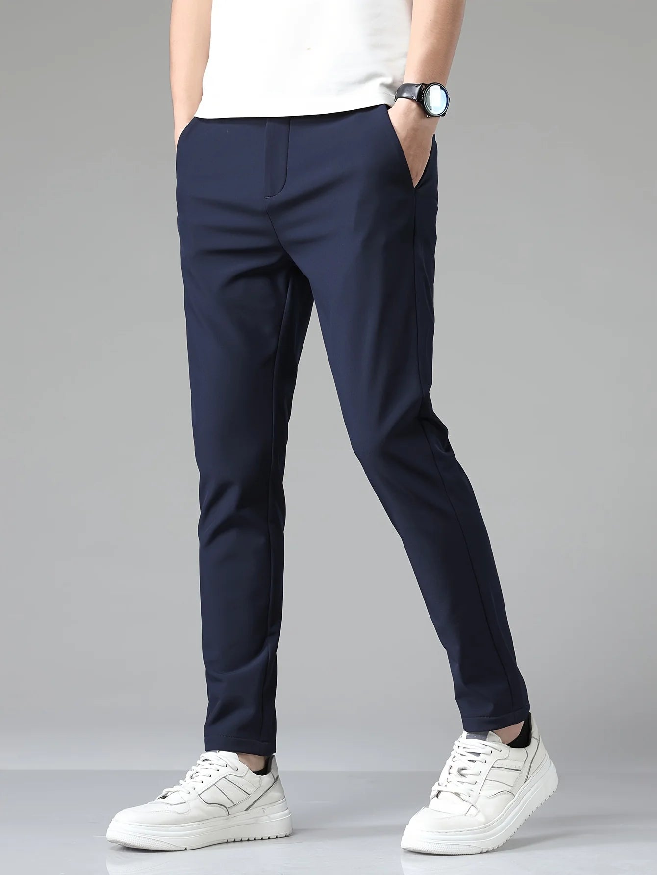 Close-up view of men's slim fit trousers showing structured woven fabric and tailored straight leg