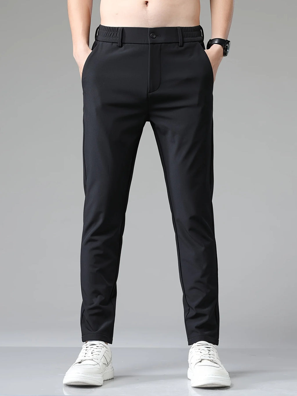 Men's navy trousers paired with casual trainers for smart-casual styling versatility