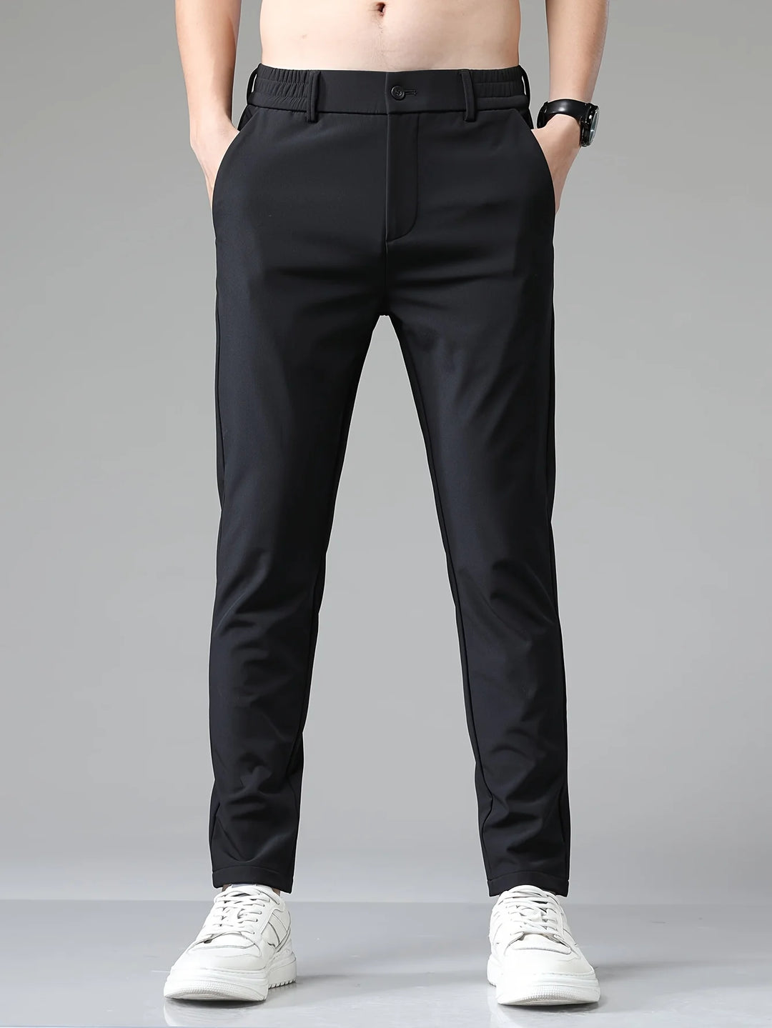 Men's navy trousers paired with casual trainers for smart-casual styling versatility