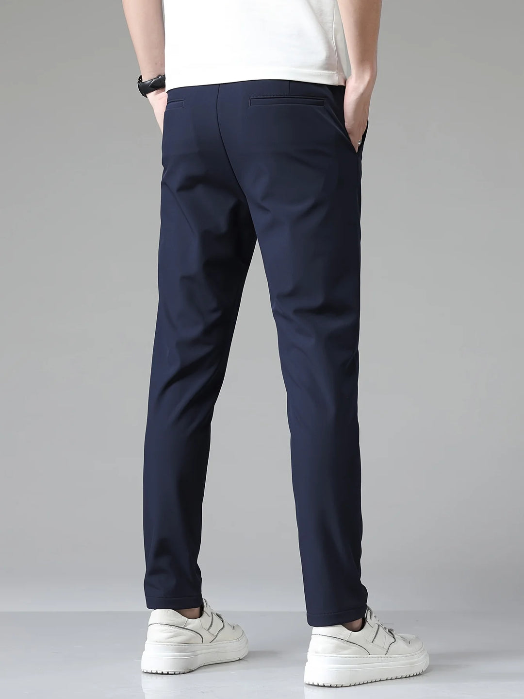 Men's slim fit trousers in navy displaying tailored silhouette and modern straight leg
