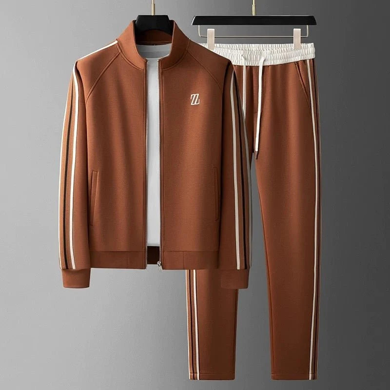 Men's tracksuit with side stripe detailing featuring zip-up jacket and matching joggers displayed on hangers