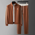 Men's tracksuit with side stripe detailing featuring zip-up jacket and matching joggers displayed on hangers