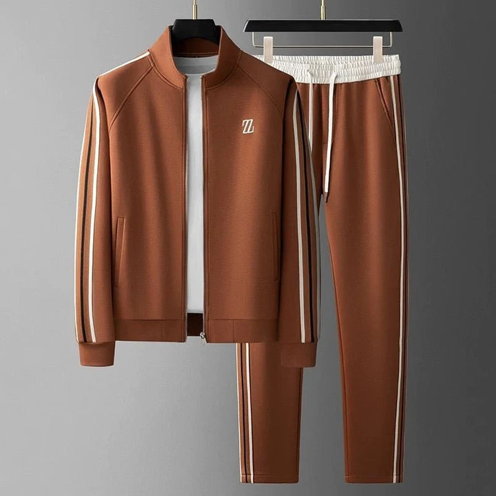 Men's tracksuit with side stripe detailing featuring zip-up jacket and matching joggers displayed on hangers