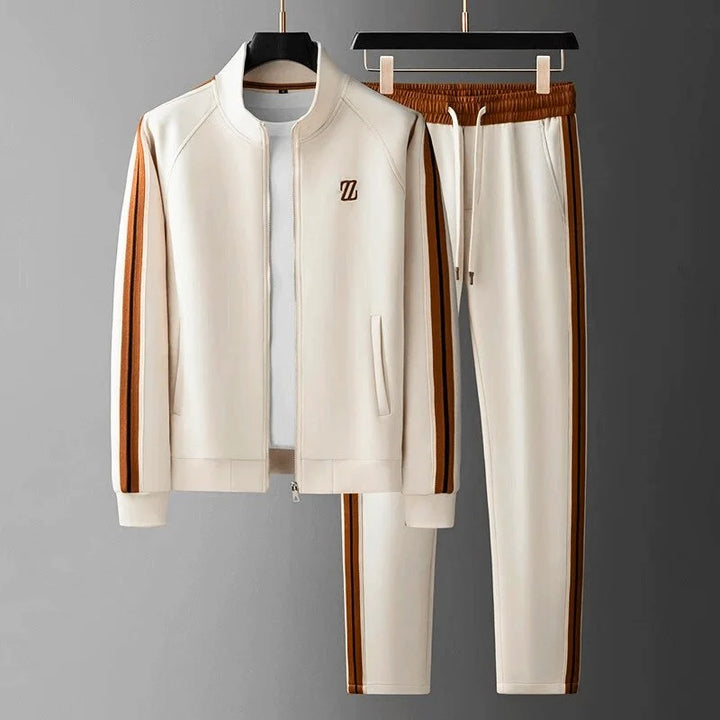 Men's tracksuit joggers showing tapered leg, ribbed cuffs, and side stripe design on neutral background