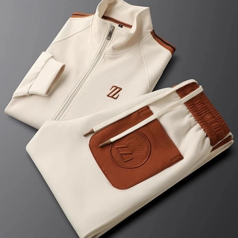 Men's tracksuit set laid flat displaying full coordination of jacket and joggers with stripe detailing