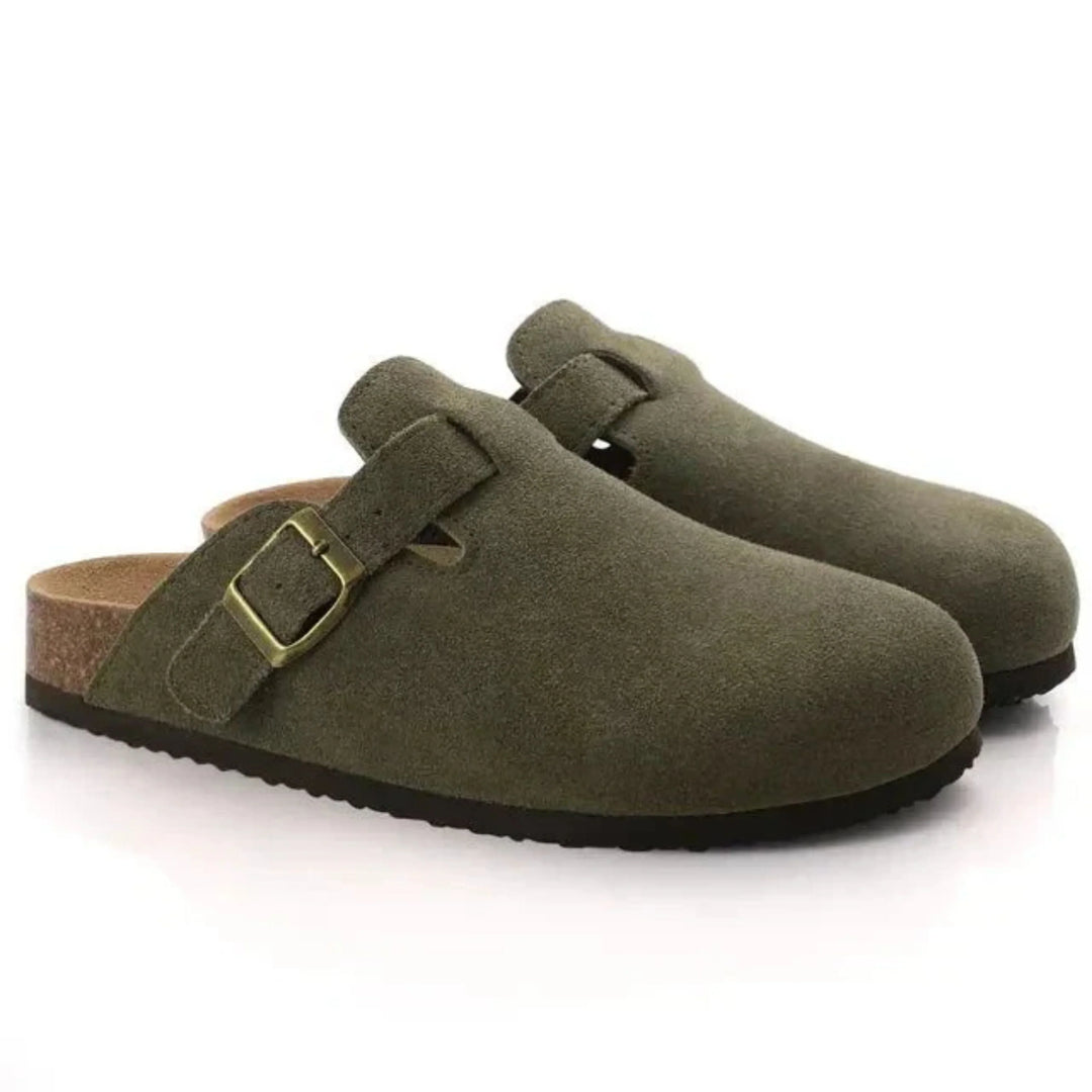 Side view of men's closed-toe clogs showing adjustable buckle detail and cork midsole construction