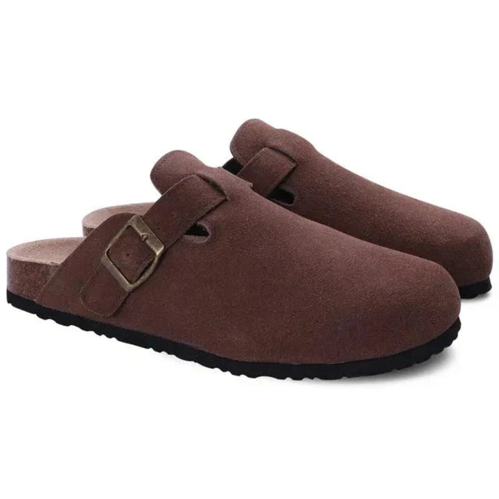 Detail of adjustable metal buckle strap on men's clogs with contoured footbed support
