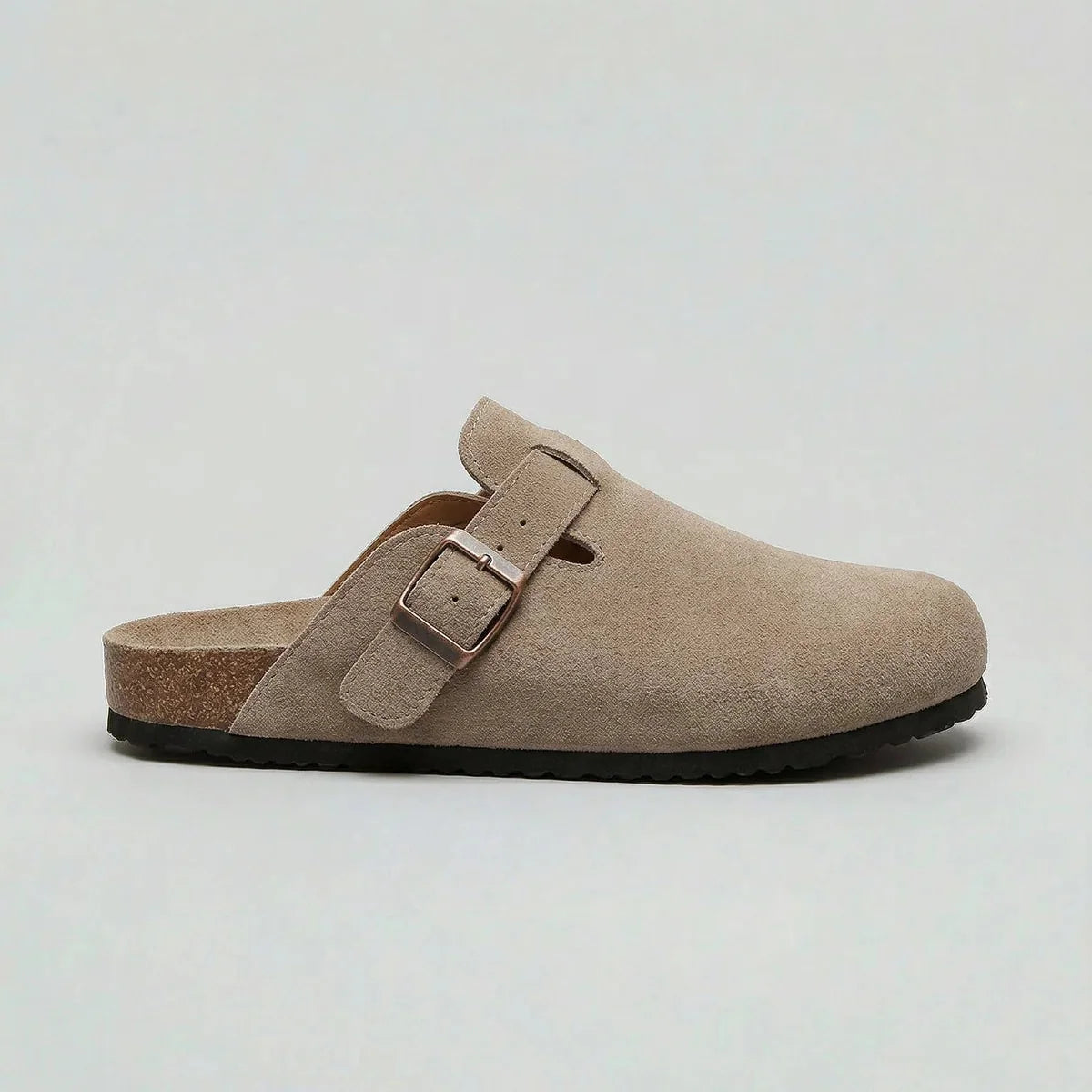 Side view of men's suede clogs in beige with adjustable buckle strap and cork footbed