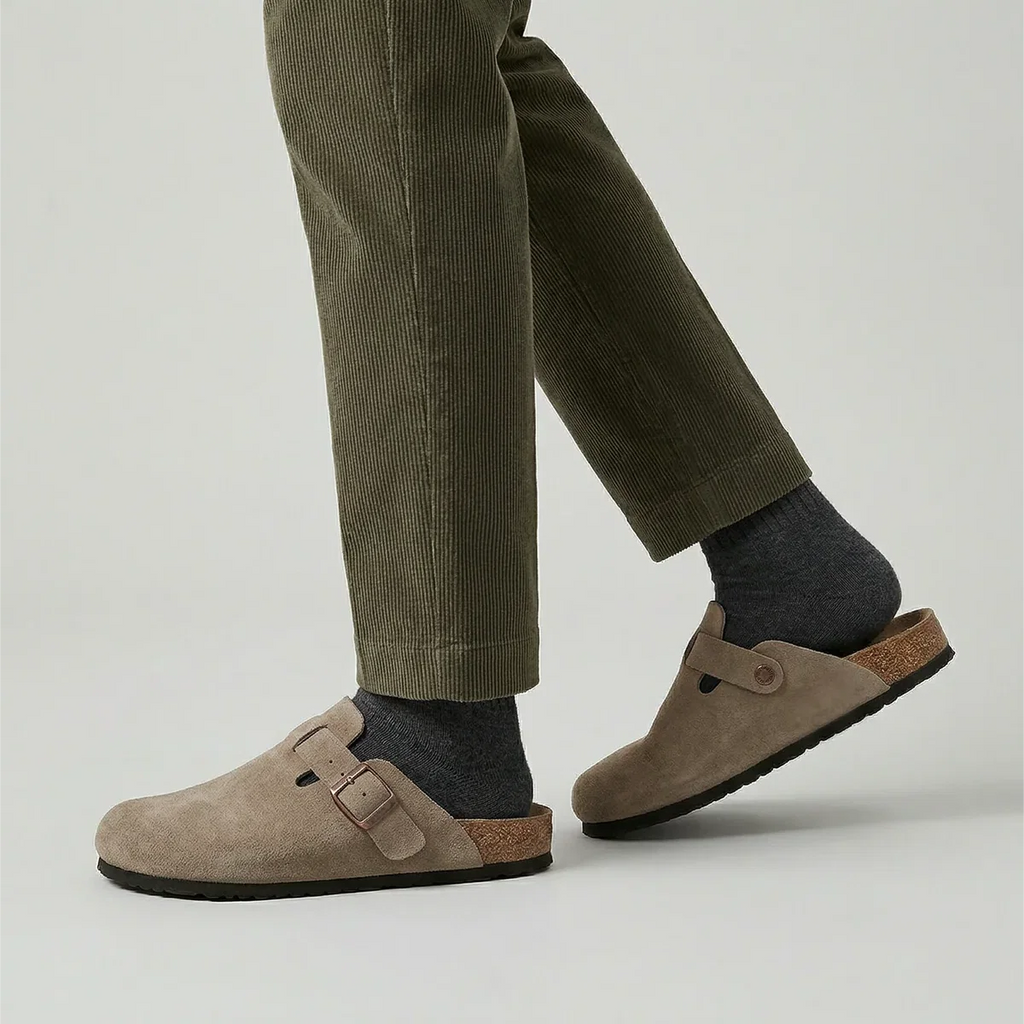 Men's beige suede clogs showing closed-toe design with textured outsole and buckle fastening