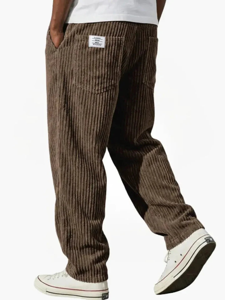 Grey ribbed corduroy trousers with functional side pockets and adjustable waist