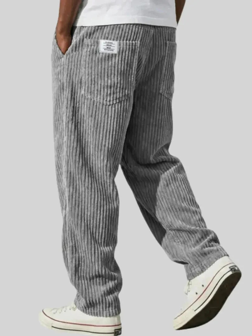 Close-up view of men's corduroy trousers showing ribbed texture detail and straight leg silhouette