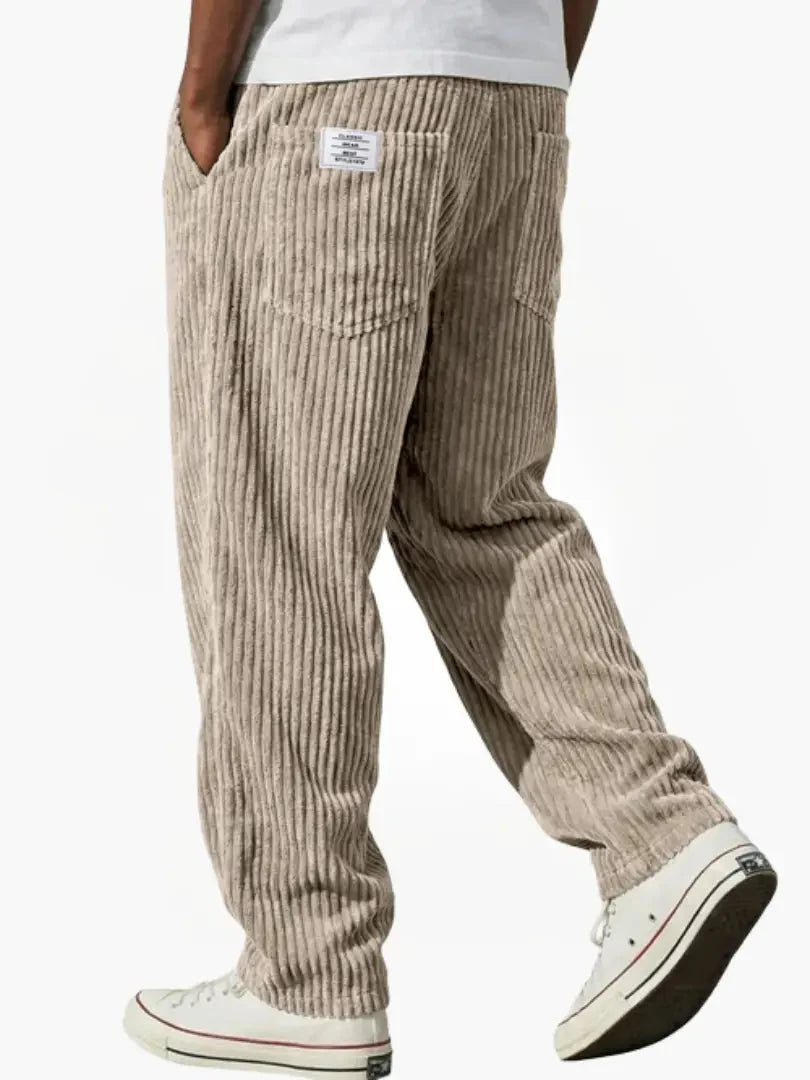 Men's corduroy trousers paired with casual trainers showing full-length straight leg cut