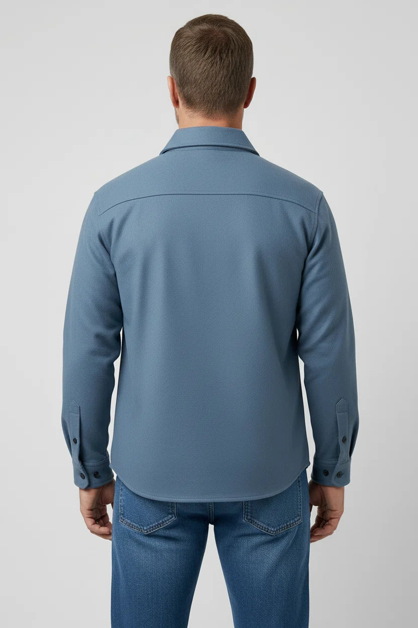 Close-up view of men's overshirt jacket showing structured collar and button-flap chest pockets