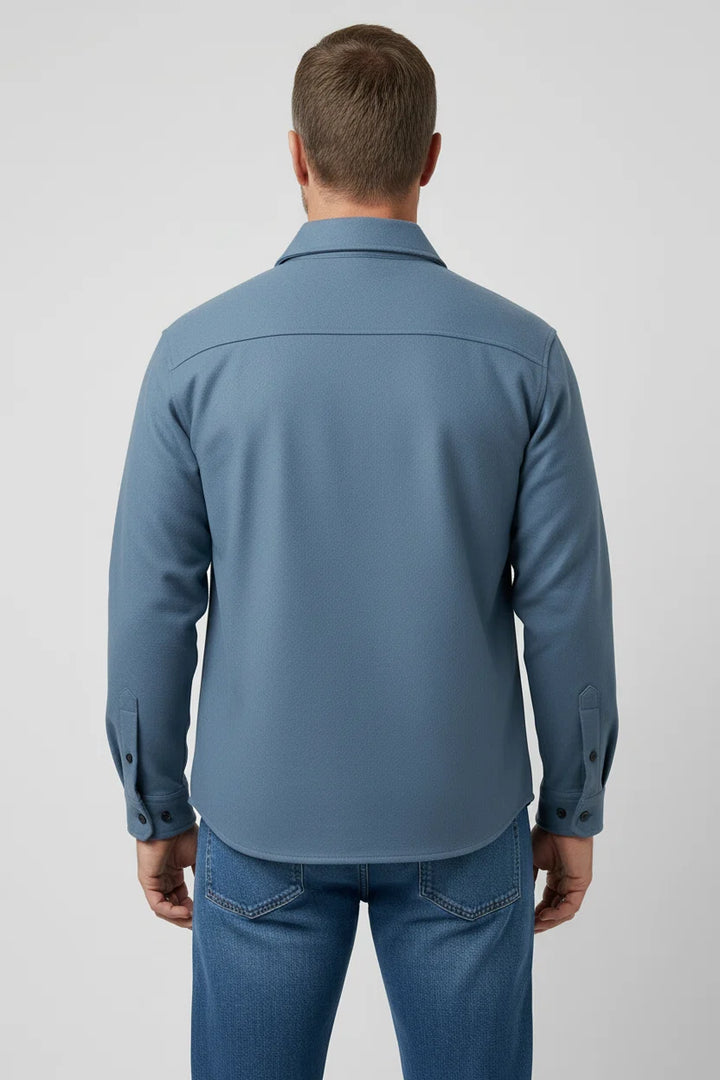 Close-up view of men's overshirt jacket showing structured collar and button-flap chest pockets