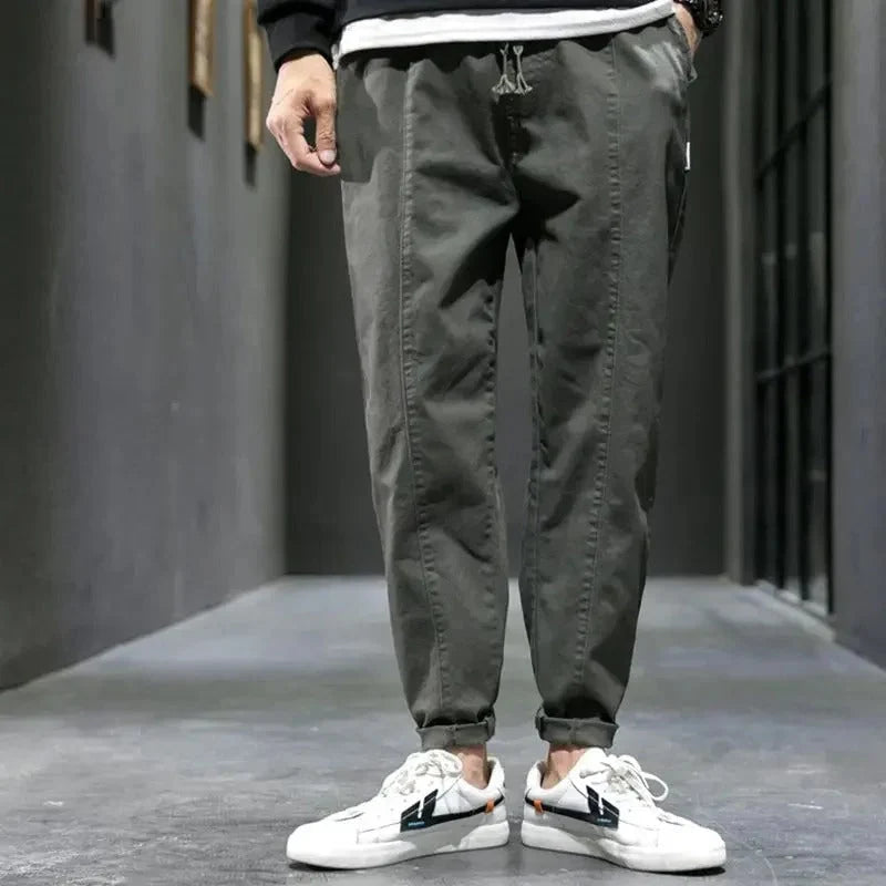 Close-up of side pocket detail on men's tapered joggers with smooth woven finish