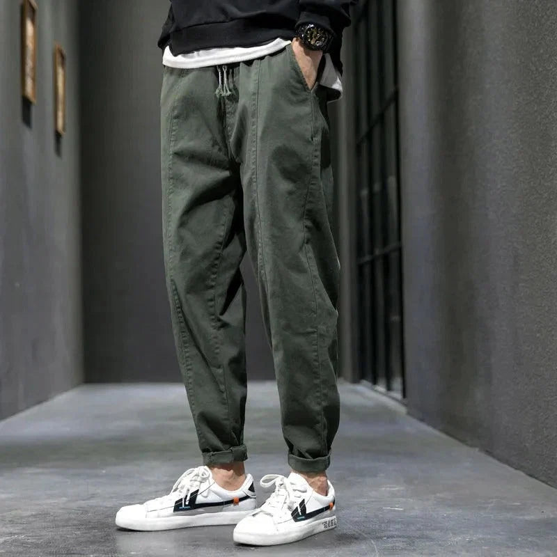 Side view of men's tapered joggers featuring elasticated waistband and practical side pockets