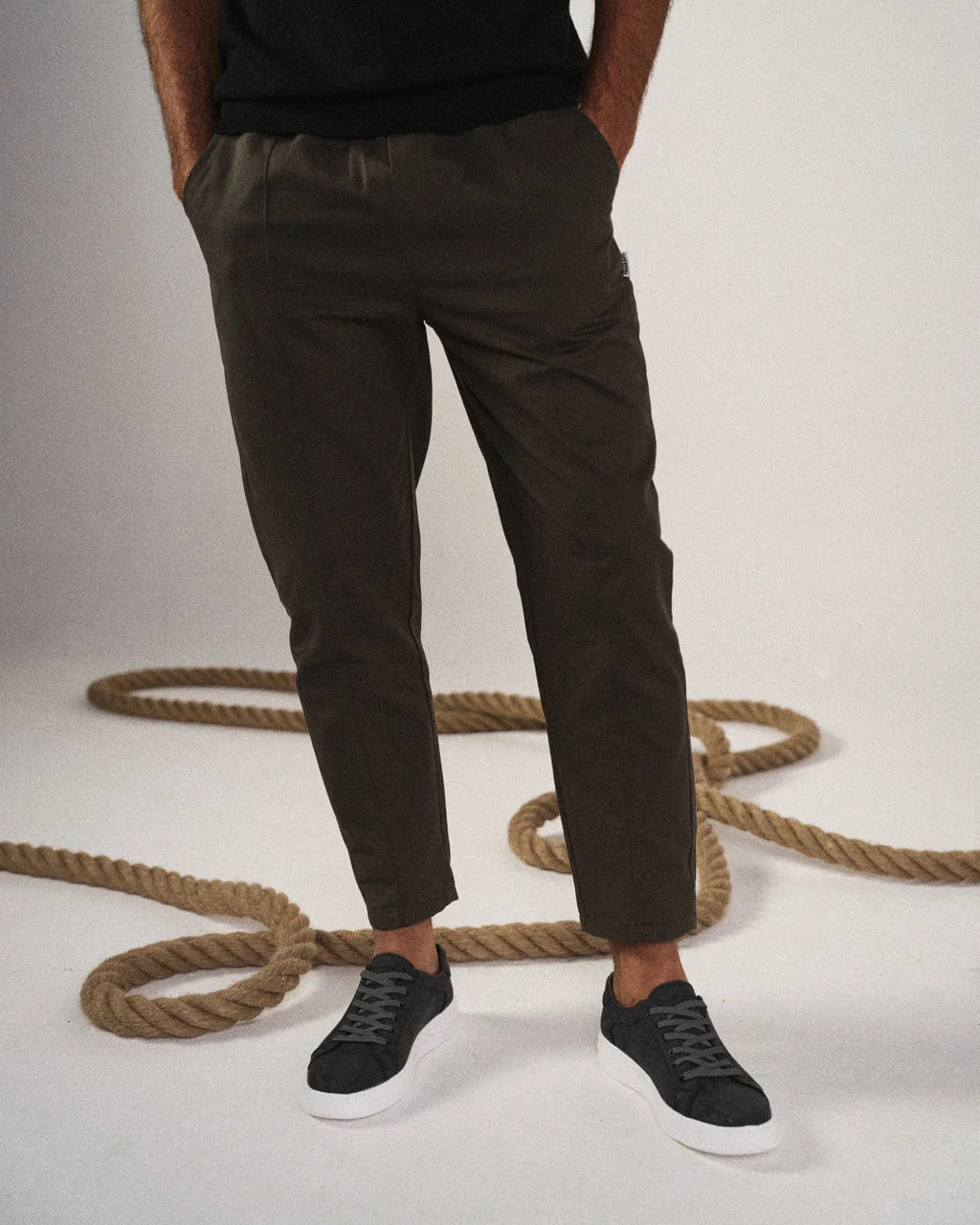 Full-length view of men's tapered joggers in black showing clean silhouette and comfortable fit