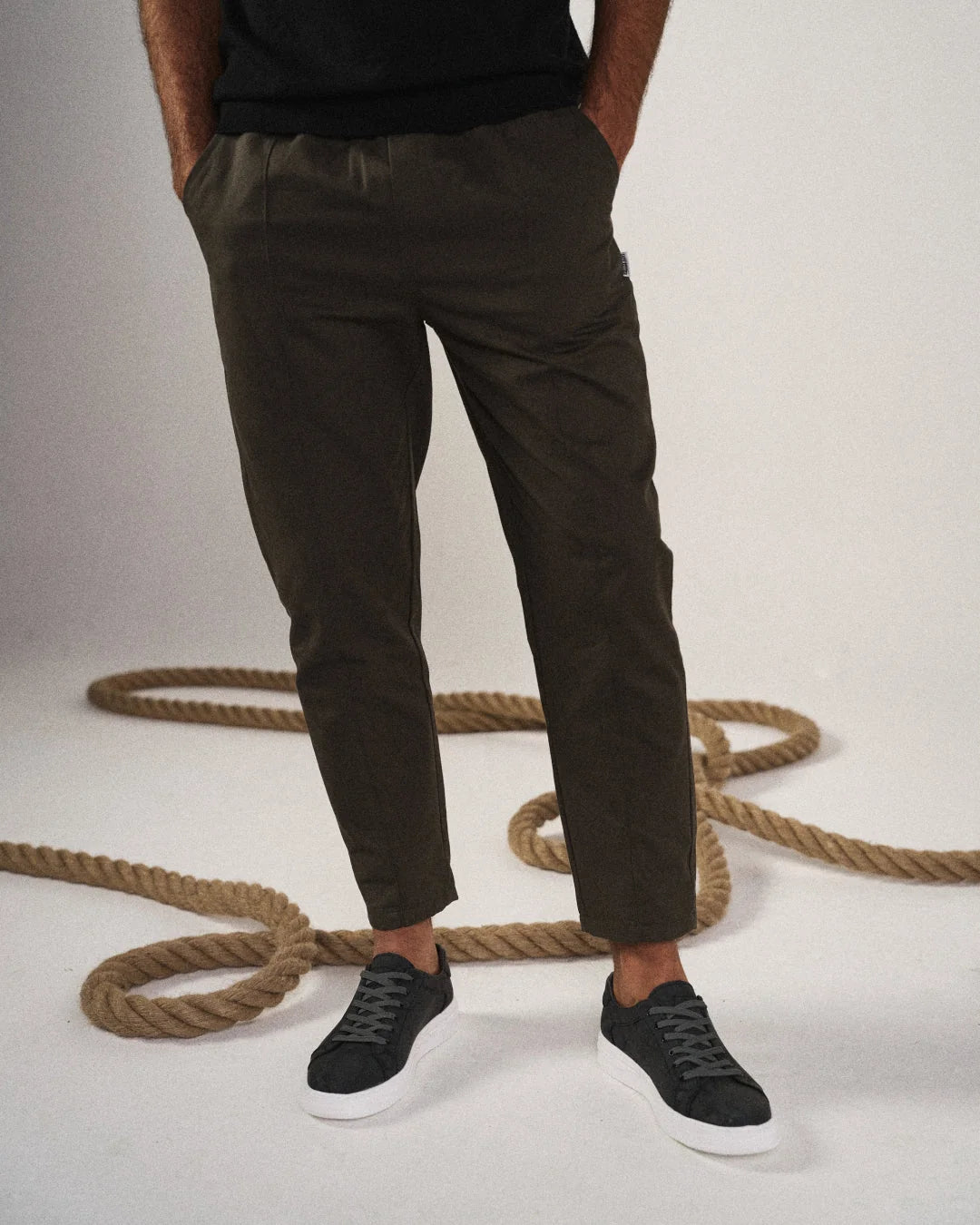 Full-length view of men's tapered joggers in black showing clean silhouette and comfortable fit
