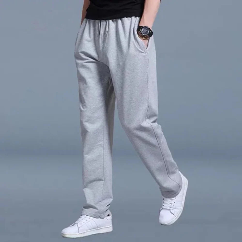 Side view of men's relaxed joggers displaying straight-leg silhouette and side pocket placement