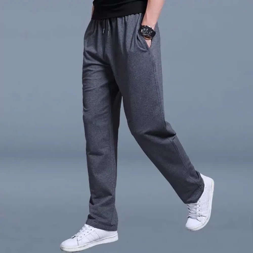 Detail shot of men's joggers waistband showing drawstring ties and elastic construction